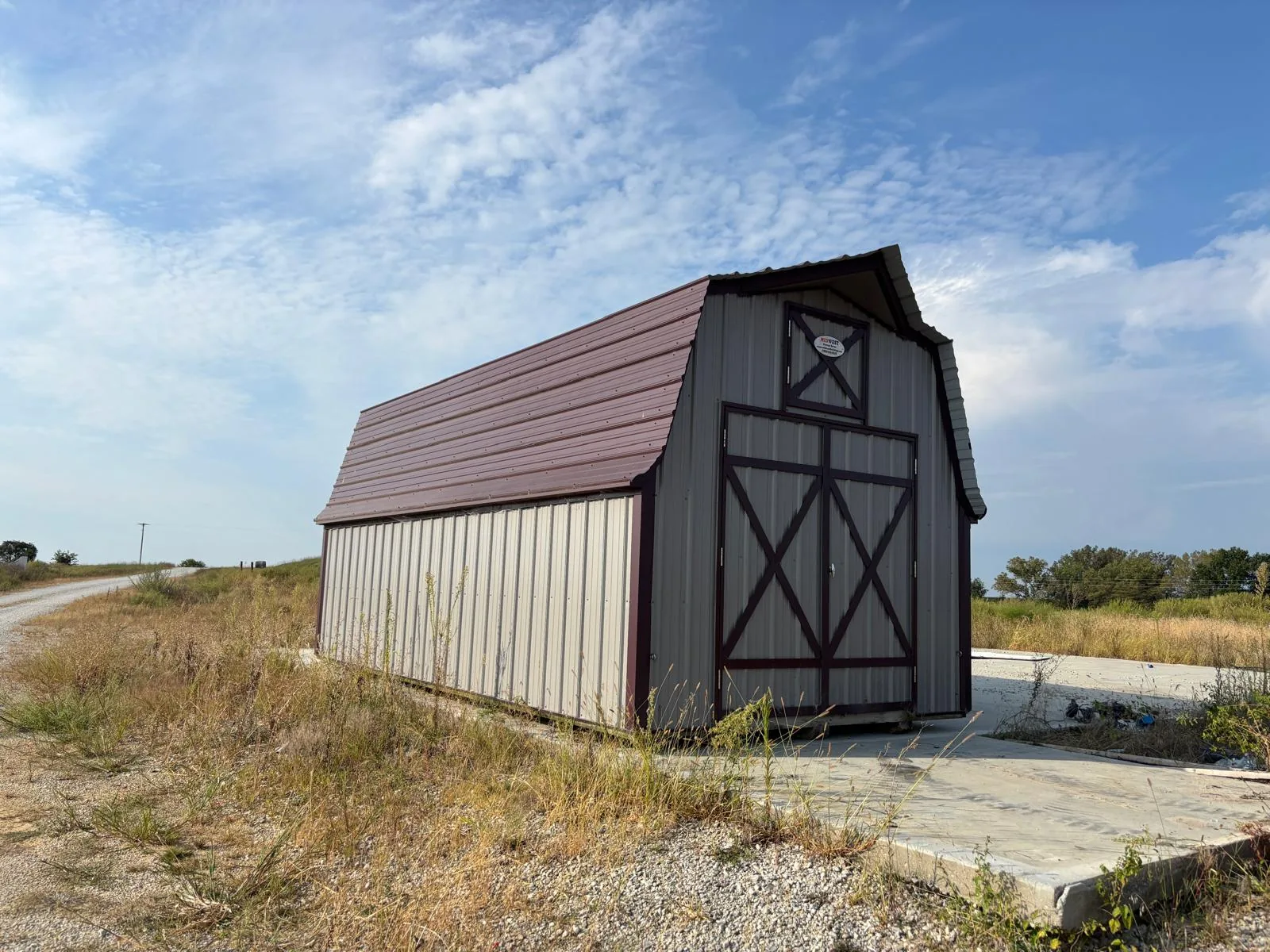 Portable barn positioned on a concrete slab