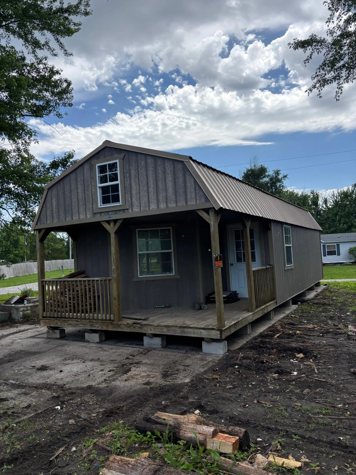 Cabin placed on foundation blocks near a pond