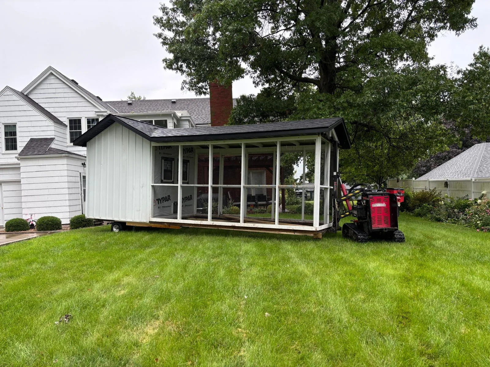 Porch shed being moved across a lawn