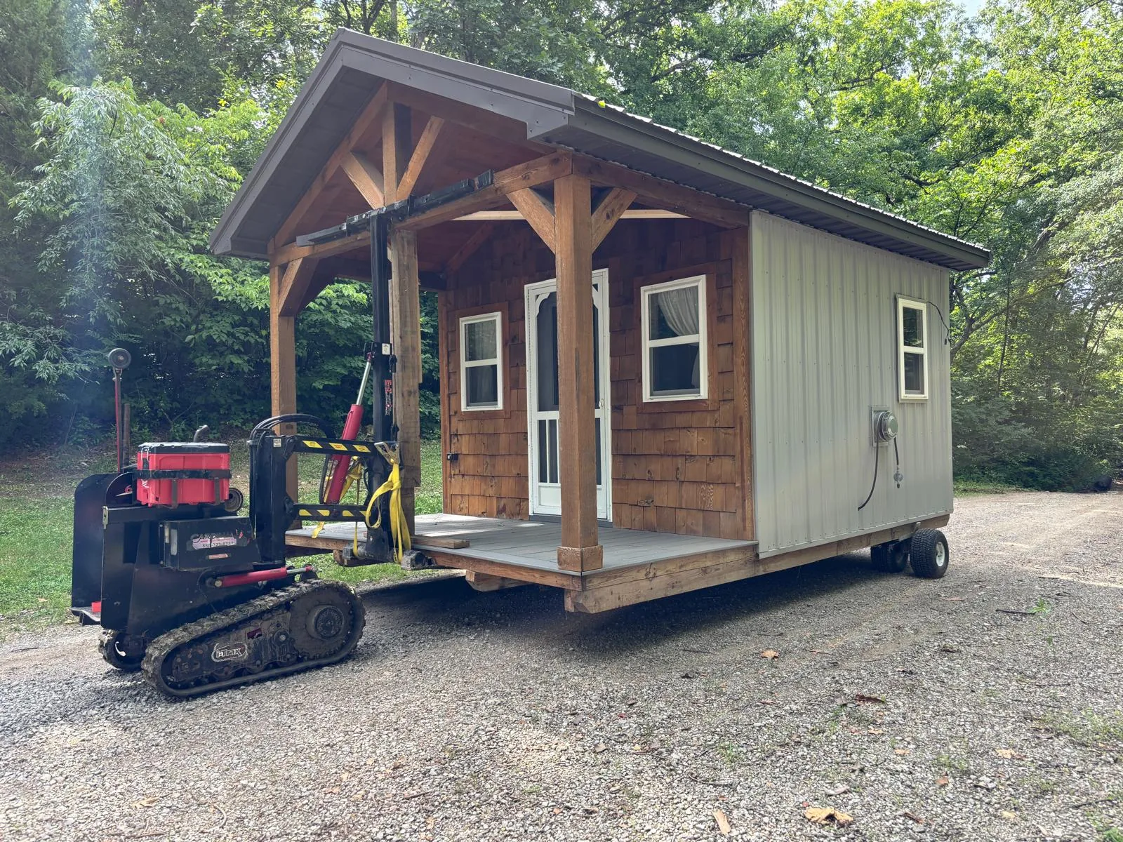 Small cabin being maneuvered by a building moving machine